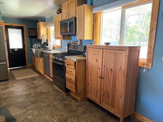 kitchen with stainless steel appliances, light countertops, and a sink