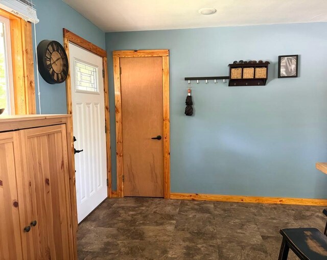 foyer featuring baseboards