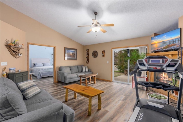 68 Crown Pointe Curv, Hudson, WI 54016 - living area with light wood-style floors, vaulted ceiling, a ceiling fan, and a textured ceiling