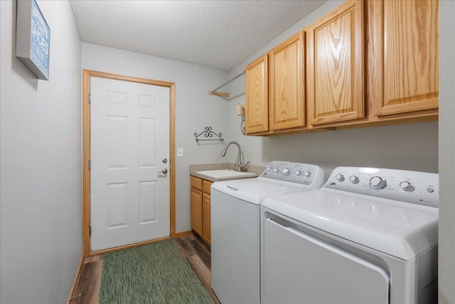 68 Crown Pointe Curv, Hudson, WI 54016 - laundry area featuring dark wood-style floors, washing machine and dryer, a textured ceiling, cabinet space, and a sink