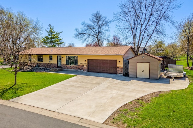 ranch-style home featuring a storage shed, a garage, a front yard, an outbuilding, and driveway