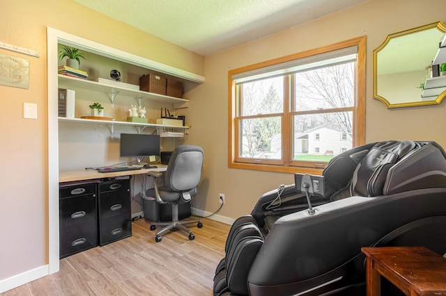 home office featuring baseboards and light wood finished floors