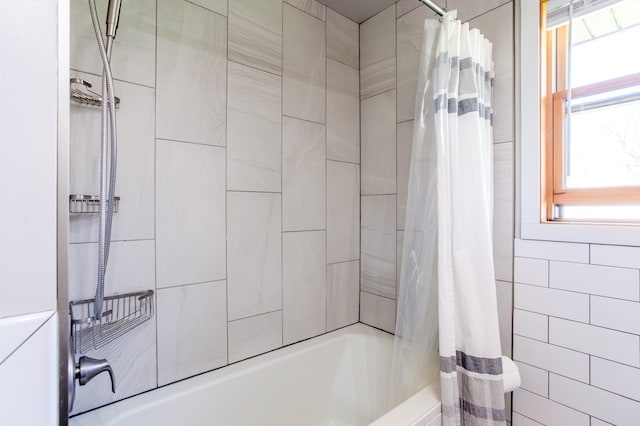bathroom featuring shower / bathtub combination with curtain