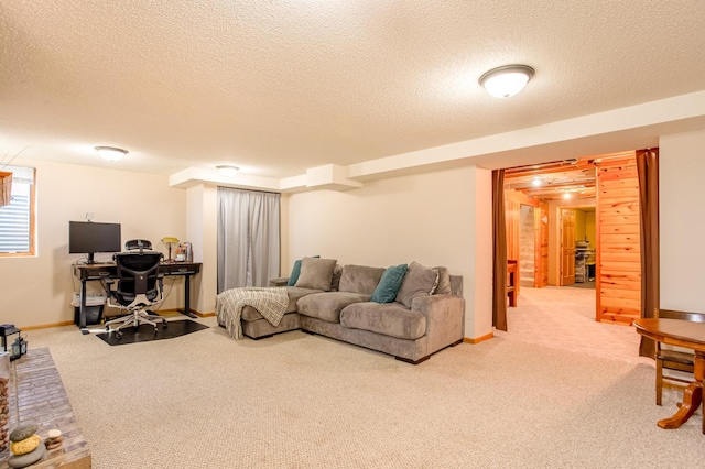 carpeted living room with baseboards and a textured ceiling