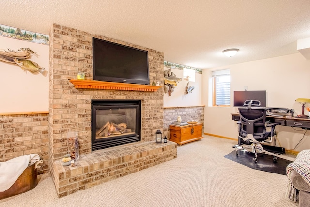 office area featuring carpet flooring, a textured ceiling, and a brick fireplace