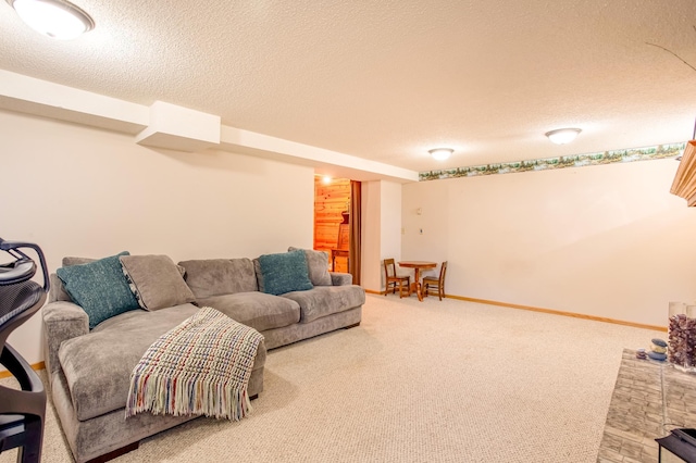 carpeted living room with baseboards and a textured ceiling