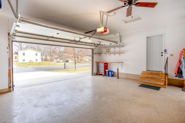 garage with a garage door opener and a ceiling fan