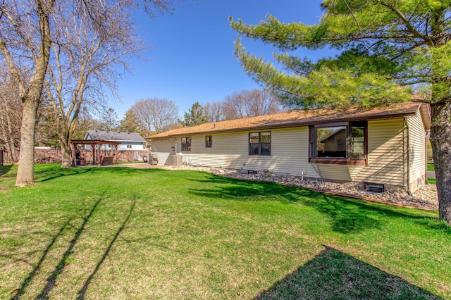 back of house with a yard and crawl space