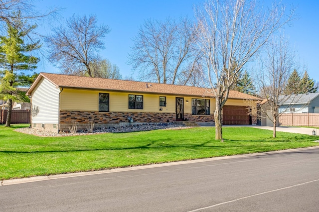 single story home with an attached garage, fence, driveway, and a front yard