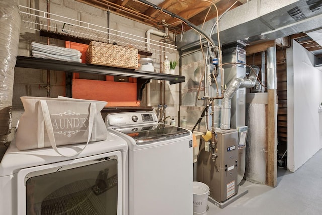 laundry room featuring gas water heater and washer and dryer