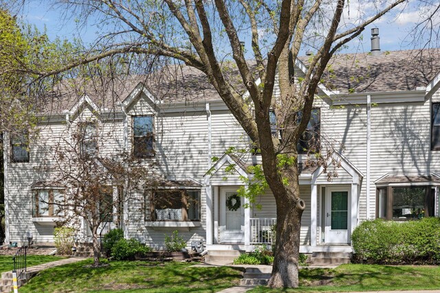 view of front of house featuring a front yard, a porch, and a chimney