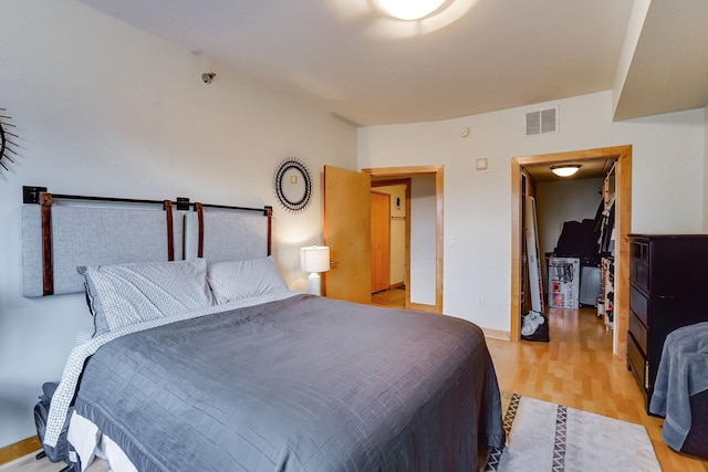 bedroom featuring light wood-style floors, baseboards, and visible vents