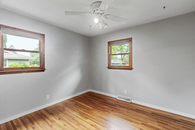 722 Navajo Ln, Mendota Heights, MN 55120 - spare room featuring baseboards, light wood-style floors, and a ceiling fan