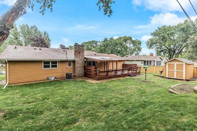 722 Navajo Ln, Mendota Heights, MN 55120 - rear view of house featuring a deck, central AC unit, and a chimney