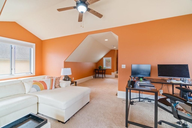 office space featuring a ceiling fan, vaulted ceiling, light carpet, and baseboards