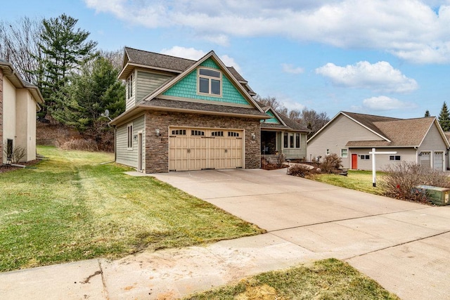 craftsman-style house featuring a garage, a front yard, driveway, and stone siding
