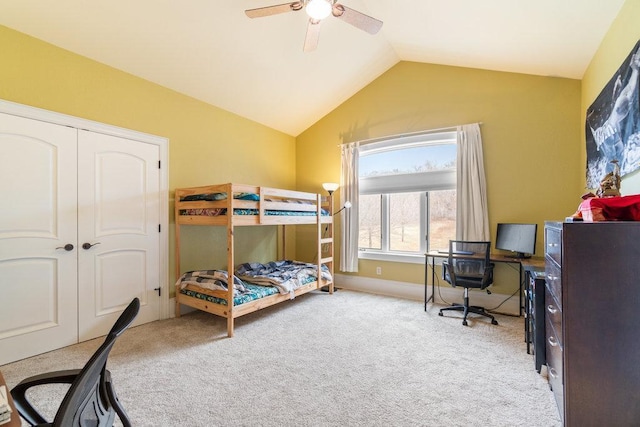 bedroom featuring lofted ceiling, a ceiling fan, carpet flooring, and a closet