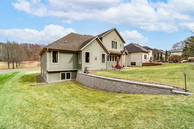 rear view of property featuring a yard