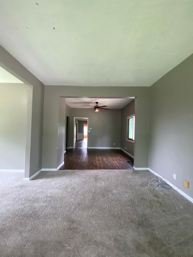 104 3rd St, Buffalo Lake, MN 55314 - empty room featuring dark colored carpet, baseboards, and ceiling fan