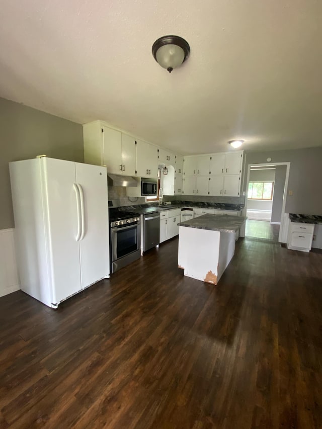 104 3rd St, Buffalo Lake, MN 55314 - kitchen with appliances with stainless steel finishes, dark countertops, a sink, and dark wood-style floors