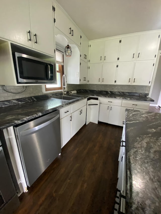 104 3rd St, Buffalo Lake, MN 55314 - kitchen with stainless steel appliances, dark wood-type flooring, tasteful backsplash, and white cabinetry