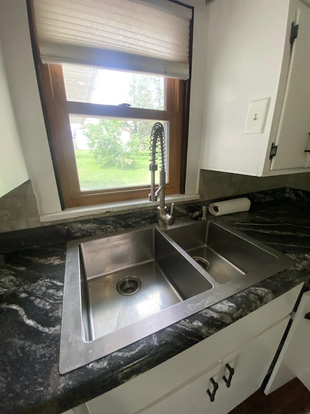 104 3rd St, Buffalo Lake, MN 55314 - kitchen view of a sink, dark countertops, and white cabinets
