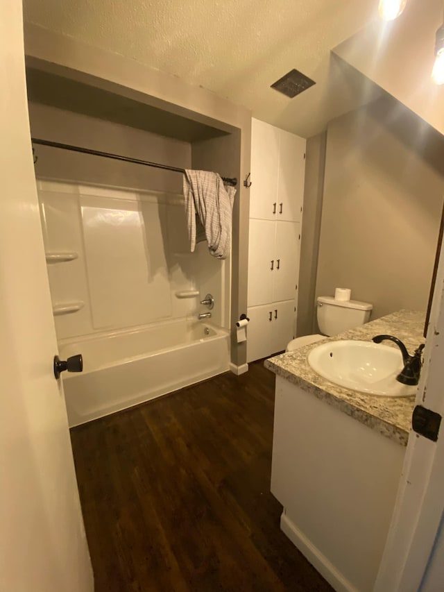 104 3rd St, Buffalo Lake, MN 55314 - full bath with wood finished floors, vanity, tub / shower combination, and a textured ceiling