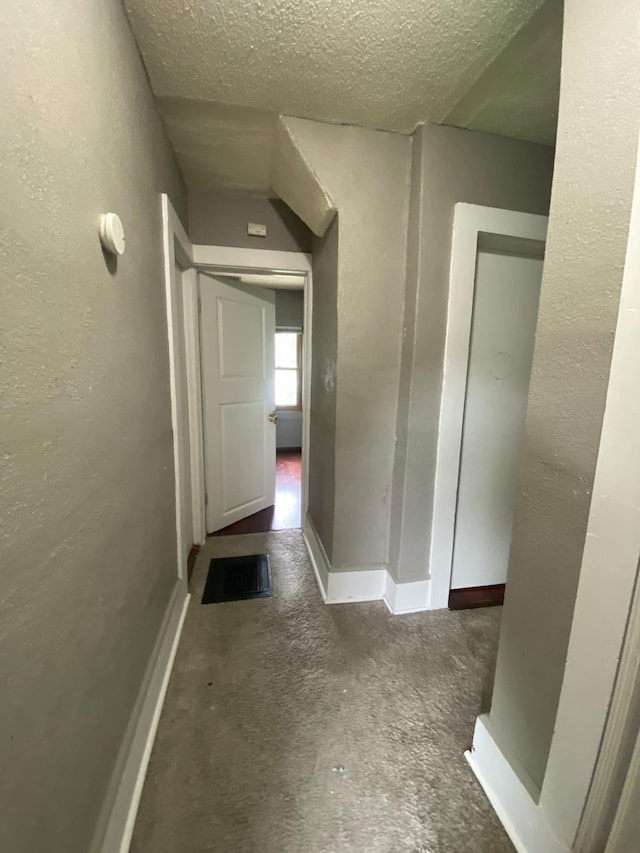 104 3rd St, Buffalo Lake, MN 55314 - corridor featuring carpet flooring, a textured ceiling, and baseboards
