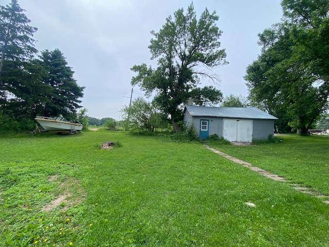 104 3rd St, Buffalo Lake, MN 55314 - view of green lawn featuring an outbuilding and a garage