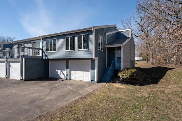 view of front of home featuring an attached garage and aphalt driveway