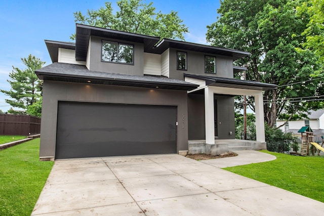 5012 Hankerson Ave, Edina, MN 55436 - view of front facade with an attached garage, driveway, stucco siding, a playground, and covered porch
