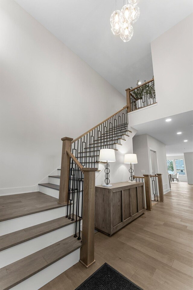 5012 Hankerson Ave, Edina, MN 55436 - stairs featuring wood finished floors, a chandelier, and a high ceiling