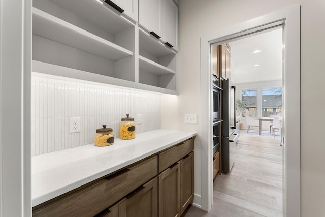 5012 Hankerson Ave, Edina, MN 55436 - bar featuring tasteful backsplash, light wood finished floors, and oven