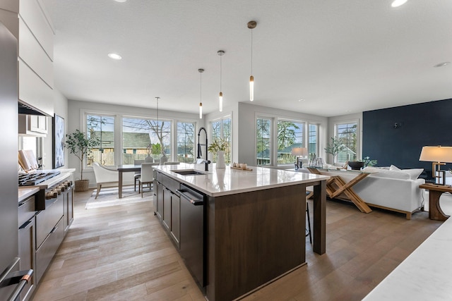 5012 Hankerson Ave, Edina, MN 55436 - kitchen with light wood-type flooring, recessed lighting, stainless steel appliances, open floor plan, and a kitchen bar