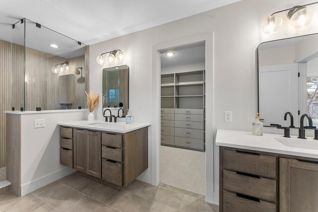 5012 Hankerson Ave, Edina, MN 55436 - bathroom with two vanities, a walk in shower, tile patterned flooring, and a walk in closet