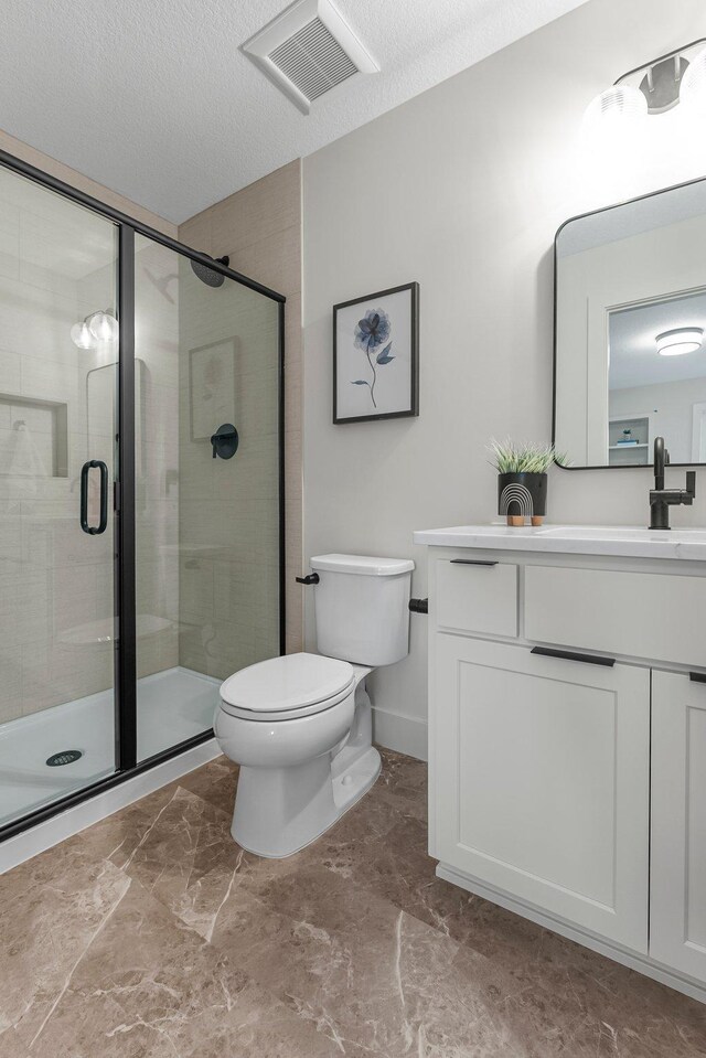 5012 Hankerson Ave, Edina, MN 55436 - full bath featuring vanity, a shower stall, marble finish flooring, and a textured ceiling