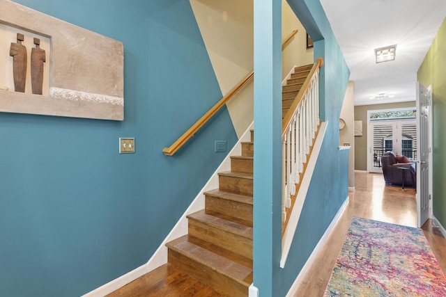 222 Ridgewood Ave, Minneapolis, MN 55403 - staircase featuring baseboards and wood finished floors