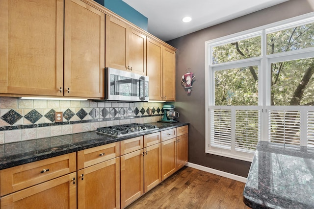 222 Ridgewood Ave, Minneapolis, MN 55403 - kitchen featuring appliances with stainless steel finishes, dark wood-style floors, backsplash, baseboards, and recessed lighting