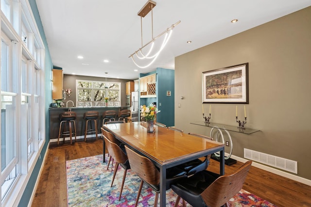 222 Ridgewood Ave, Minneapolis, MN 55403 - dining room with dark wood-style flooring, baseboards, and recessed lighting