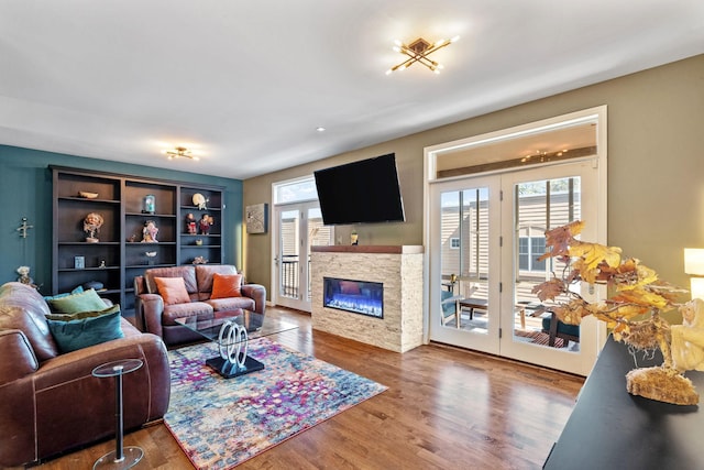 222 Ridgewood Ave, Minneapolis, MN 55403 - living room featuring wood finished floors, a stone fireplace, and french doors