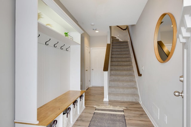 mudroom featuring light wood-style floors and baseboards