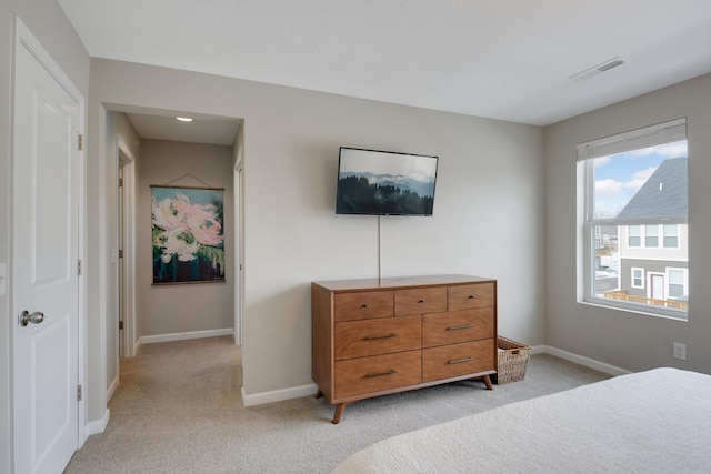 bedroom featuring light carpet, baseboards, and visible vents