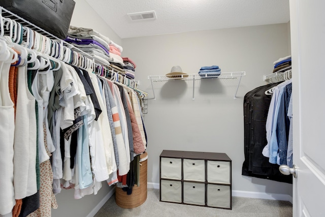 walk in closet featuring carpet flooring and visible vents