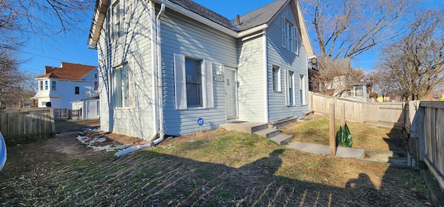 rear view of property with a fenced backyard