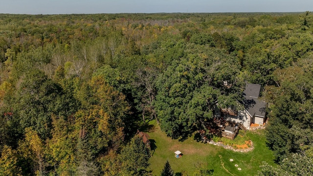 view of subject property featuring a heavily wooded area