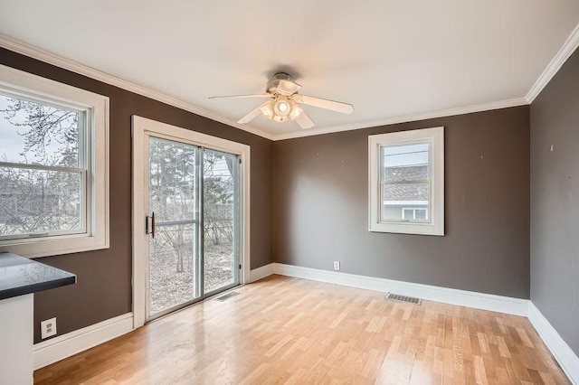unfurnished room featuring visible vents, baseboards, light wood finished floors, and a ceiling fan