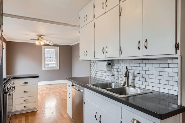 kitchen featuring ceiling fan, a sink, ornamental molding, and appliances with stainless steel finishes
