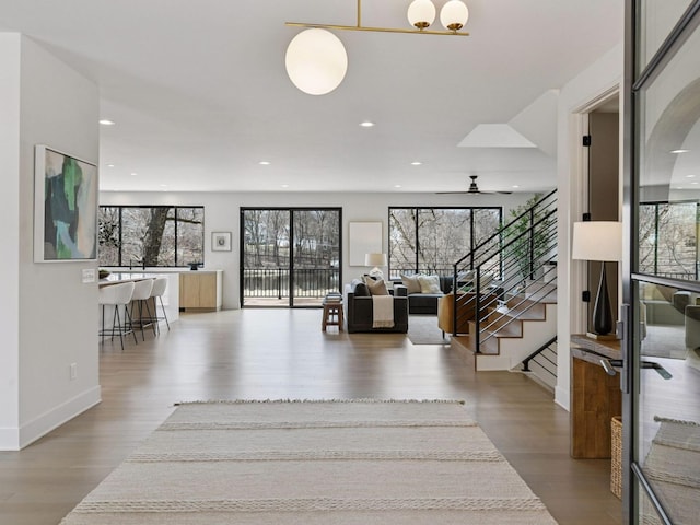 251 Glenbrook Rd N, Wayzata, MN 55391 - foyer featuring wood finished floors, plenty of natural light, stairs, ceiling fan, and recessed lighting