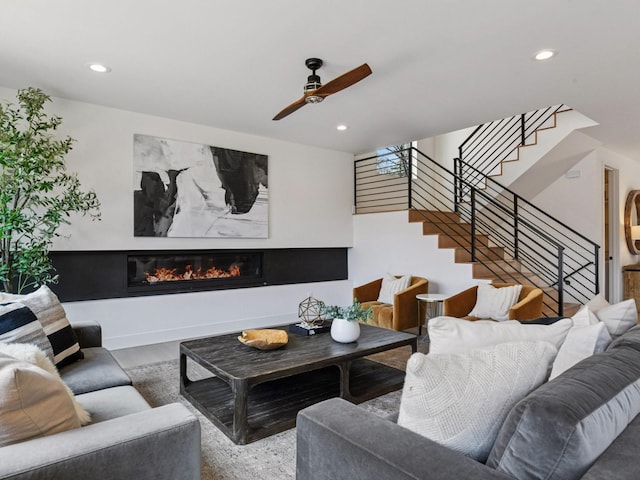 251 Glenbrook Rd N, Wayzata, MN 55391 - living room featuring wood finished floors, stairs, ceiling fan, a glass covered fireplace, and recessed lighting