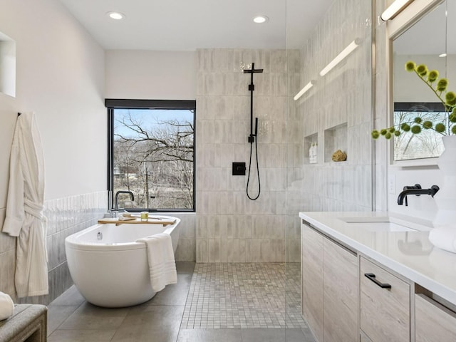 251 Glenbrook Rd N, Wayzata, MN 55391 - full bath with tile walls, a freestanding tub, vanity, a walk in shower, and tile patterned flooring
